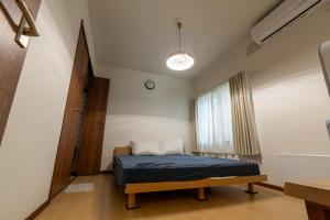 a bedroom with a bed and a window at KitaのHikari in Sapporo
