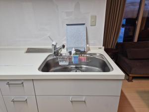 a kitchen sink with a book on top of it at KitaのHikari in Sapporo +50 photos
