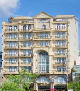 a large building with a sign on it at Tran Vinh Hotel in Bạc Liêu