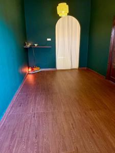 an empty room with a wooden floor and a white door at Liv Bumi Oasis in Pantai Cenang +31 photos