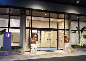 a store front of a building with large windows at Community & Spa Naha Central Hotel in Naha