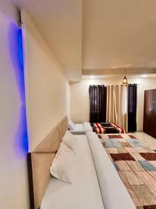 a bedroom with a large bed in a room at Taj Castle Homestay in Agra