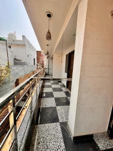 an empty corridor of a building with a checkered floor at Taj Castle Homestay in Agra
