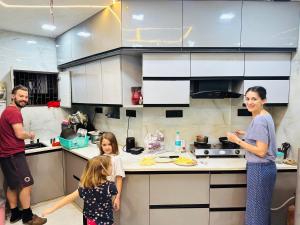 a group of people standing in a kitchen at Taj Castle Homestay in Agra