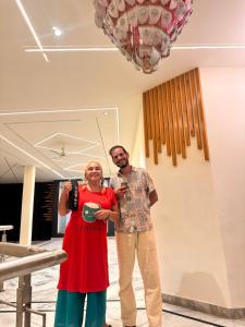 two people standing next to each other in a room at Taj Castle Homestay in Agra