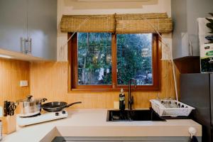 a kitchen with a sink and a window at Katig Beachfront Boutique Hotel in General Luna