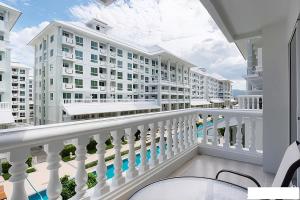 a balcony with a view of a building at 1 Bedroom Beachside Condo in Cha-am in Ban Bang Sai Yoi (1)