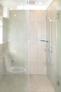 a bathroom with a shower with a glass door at Hotel Bond in Yangon