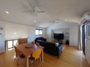 a living room with a table and a couch at Blue Oasis in Esperance