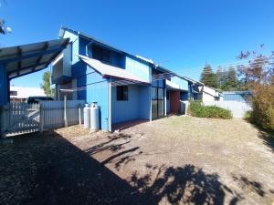 a blue house with a yard in front of it at Blue Oasis in Esperance