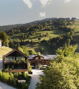 a view of a building with a mountain in the background at Haus Jausern in Saalbach-Hinterglemm