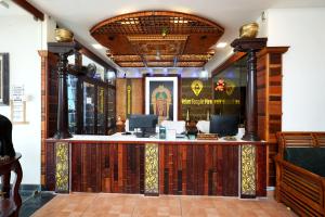 a lobby of a restaurant with a counter at Velan Temple View in Palni