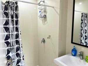a bathroom with a shower and a sink at Grand Cenia Residences in Cebu City +14 photos
