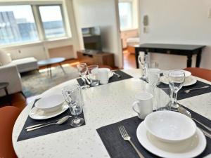 a table with plates and glasses on top of it at Grand Cenia Residences in Cebu City
