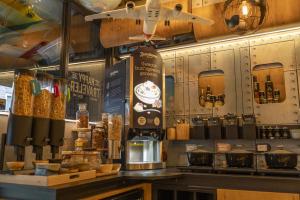 a coffee shop with a counter with a coffee maker at Hotel The Happy Traveler in Groningen +6 photos