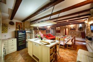 a kitchen with a table and a dining room at Villa Alma Komiza Island Vis in Komiža