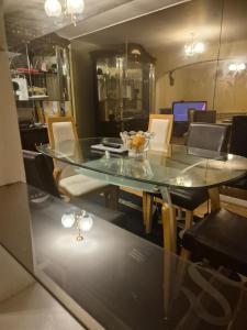 a dining room with a glass table and chairs at Three bedroom house with a garden in Redhill +90 photos