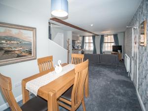 a dining room with a wooden table and chairs at The Crown in Poole