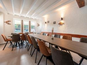 a conference room with a long table and chairs at Große Gruppenunterkunft im Nationalpark Eifel mit Bar und Terrasse in Schleiden