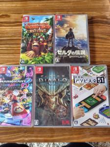 a pile of video games on a table at The Deck Villa KitaKaruizawa in Tsumagoi