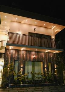 a building with a balcony with plants on it at Lazo EcoSpot Vythiri , Wayanad in Vythiri