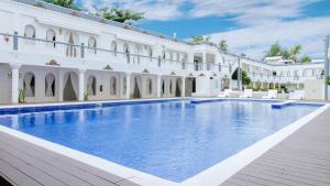 a large white building with a large swimming pool at Boracay Summer Palace Hotel in Boracay
