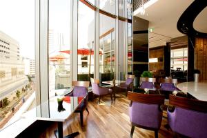 a dining room with purple chairs and a table at Hotel Trusty Osaka Abeno in Osaka
