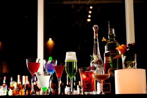 a group of wine bottles and glasses on a table at Hotel Trusty Osaka Abeno in Osaka