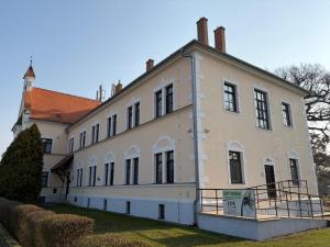 a large white building with a red roof at Koleje Zámeček in Lednice