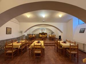 a dining room with tables and chairs and an archway at Koleje Zámeček in Lednice