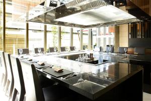 a large dining room with a long table and chairs at Hotel Trusty Osaka Abeno in Osaka