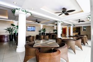 a restaurant with tables and chairs and a ceiling at Boracay Summer Palace Hotel in Boracay