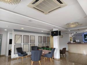 a lobby with chairs and a bar in a building at Sunstone Hotel in George Town