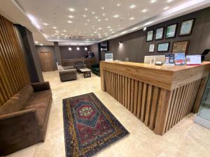 a lobby with a bar and a couch and a rug at Rain Golden Hotel in Istanbul