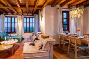 a living room with a couch and a table at Meliades Luxury Villas in Arachova