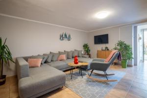 a living room with a couch and a table at Balkonett Vendégház in Balatonfüred +24 photos