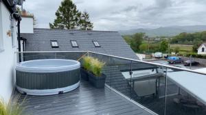 a hot tub on the balcony of a house at Snowdon Studio Apartment in Colwyn Bay