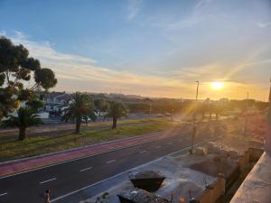 a view of a road with the sunset in the background at Manchester Heights in Cape Town