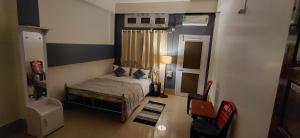 a small bedroom with a bed and a window at Pipitsnest 2 homes in Tezpur