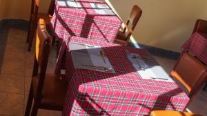 a table with a red checkered table cloth on it at Paran Amboseli Resort in Kimana