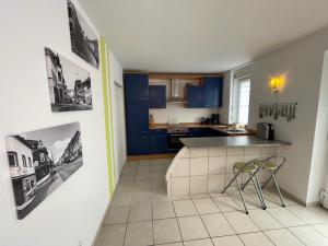 a kitchen with blue cabinets and a counter top at Ferienwohnung Karin in Losheim