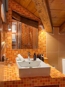 a bathroom with a white sink and orange tiles at Meliades Luxury Villas in Arachova +108 photos