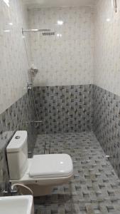 a bathroom with a toilet and a sink at Hotel Sivani in Kalakkādu