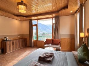 a bedroom with a bed and a large window at The Trippy Tribe Manali in Manāli +45 photos