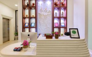 an apple store with a display with flowers on a table at Homewood Hotel Siem Reap in Siem Reap