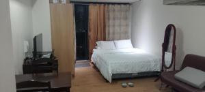 a bedroom with a bed and a couch and a window at Knightsbridge Residences with Free Pool, Sauna, Fast WiFi, Gym and Kitchen in Manila +17 photos