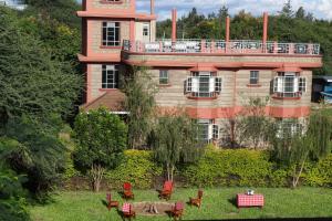a building with a table and chairs in front of it at Paran Amboseli Resort in Kimana
