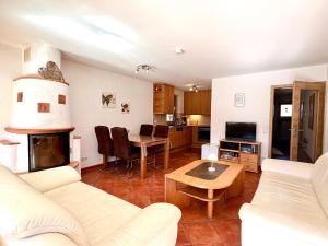 a living room with a white couch and a table at Ferienwohnung Bergpanorama Schönau in Schönau am Königssee