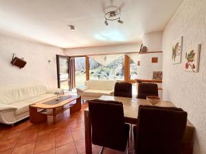 a living room with a table and a couch at Ferienwohnung Bergpanorama Schönau in Schönau am Königssee