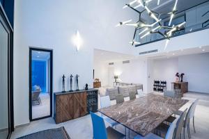 a dining room and kitchen with a table and chairs at Luxury Seafront Villa Miracul Korcula with Pool in Blato